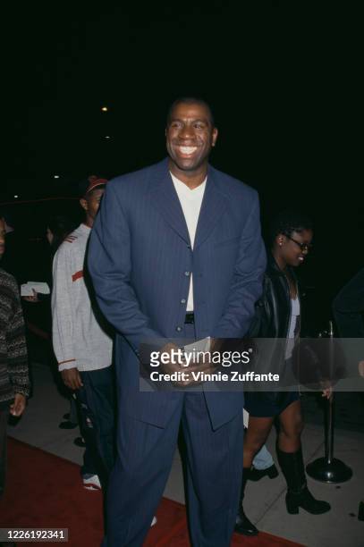 American basketball player Magic Johnson attends the premiere of 'Light It Up', held at the Cinerama Dome Theater in Los Angeles, California, 4th...