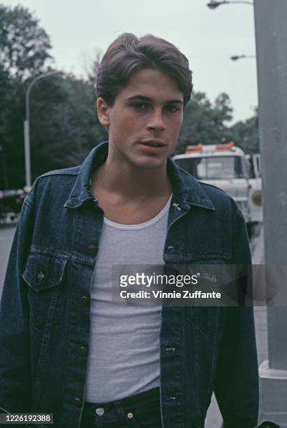 American actor Rob Lowe wearing a white t-shirt beneath a dark blue Levis denim jacket, November 1983.