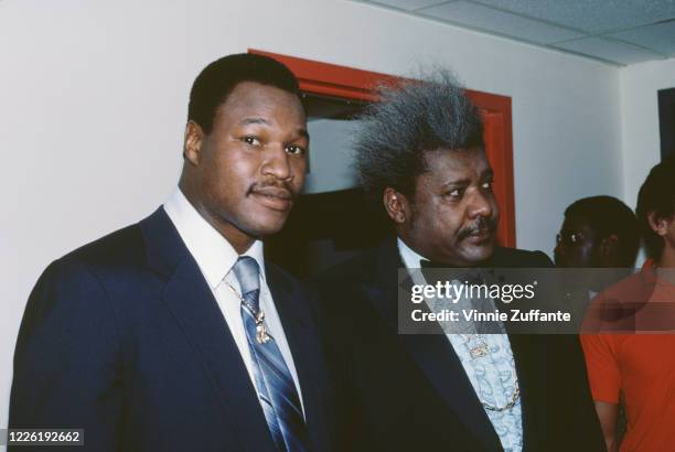 American heavyweight boxer Larry Holmes with American boxing promoter Don King, circa 1983.
