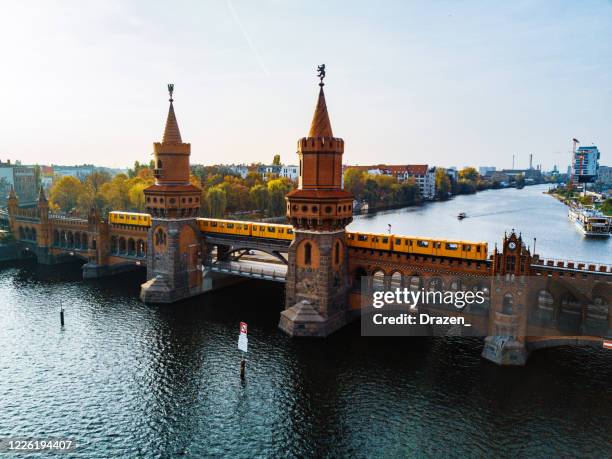 aerial view of berlin with view of oberbaum bridge and yellow u-bahn on sunny autumn day - oberbaumbruecke stock pictures, royalty-free photos & images
