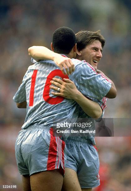 John Barnes of Liverpool and team mate Peter Beardsley embrace during the Barclays League Division One match against Manchester United played at Old...