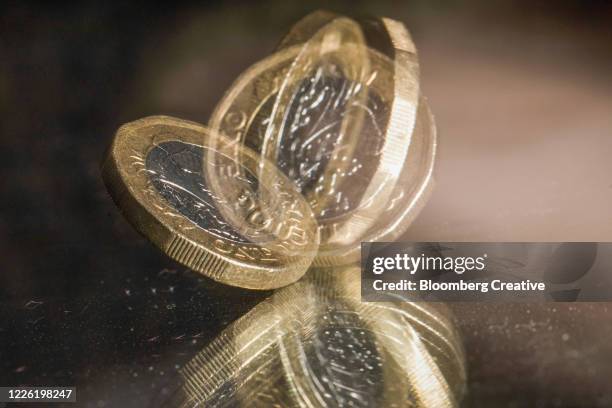 british one pound coin - spinning coin stock pictures, royalty-free photos & images