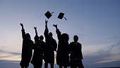 Silhouette of Graduating Students Throwing Caps In The Air