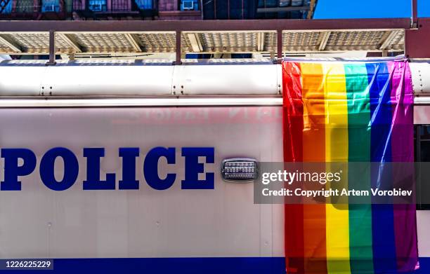 rainbow flag on a police van - police parade stock pictures, royalty-free photos & images