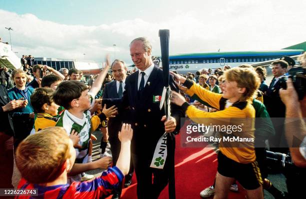 Dublin , Ireland - 1 July 1990; Republic of Ireland manager Jack Charlton is greeted by young footballers on his squad's arrival home for a...