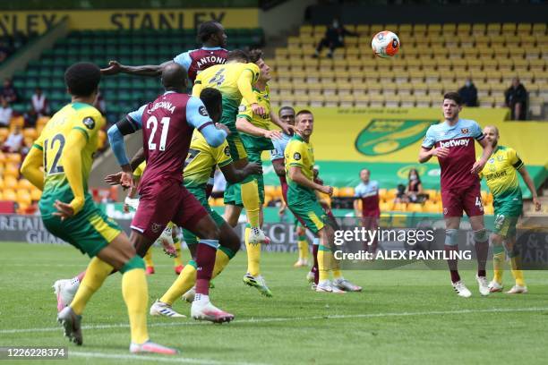 West Ham United's English midfielder Michail Antonio shoots and scores a goal during the English Premier League football match between Norwich City...