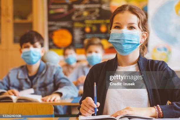 high school girl student at school wearing n95 face masks - social distancing school stock pictures, royalty-free photos & images