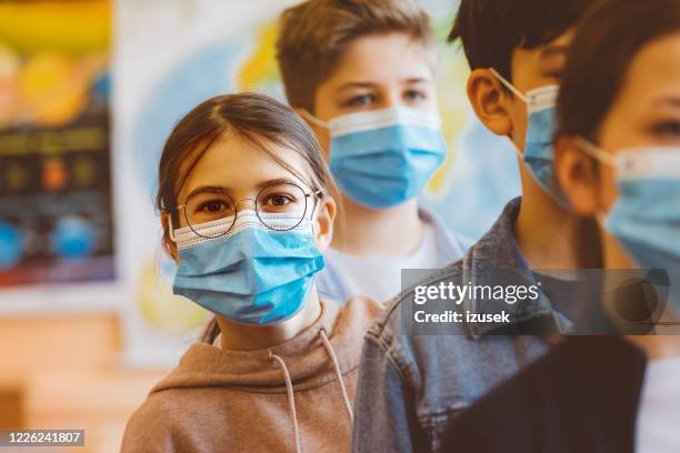 teenage girl standing among high school students - social distancing line stock pictures, royalty-free photos & images