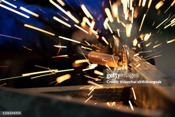 manual welding by welding torch in factory - soldered stock pictures, royalty-free photos & images