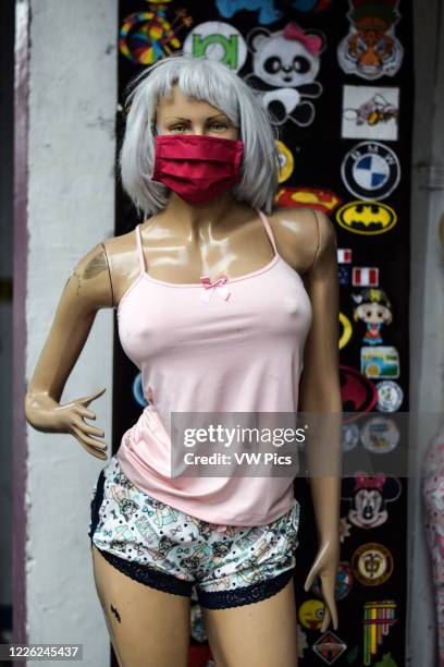 Female mannequin in shop wearing a face mask.