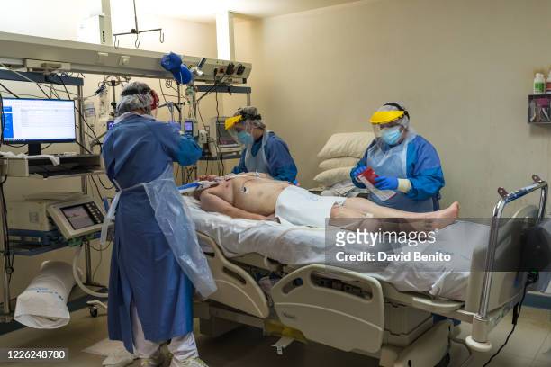 Health personnel at the intensive care unit of the University Hospital Fundacion Alcorcon treat a COVID-19 patient on May 20, 2020 in Alcorcon,...