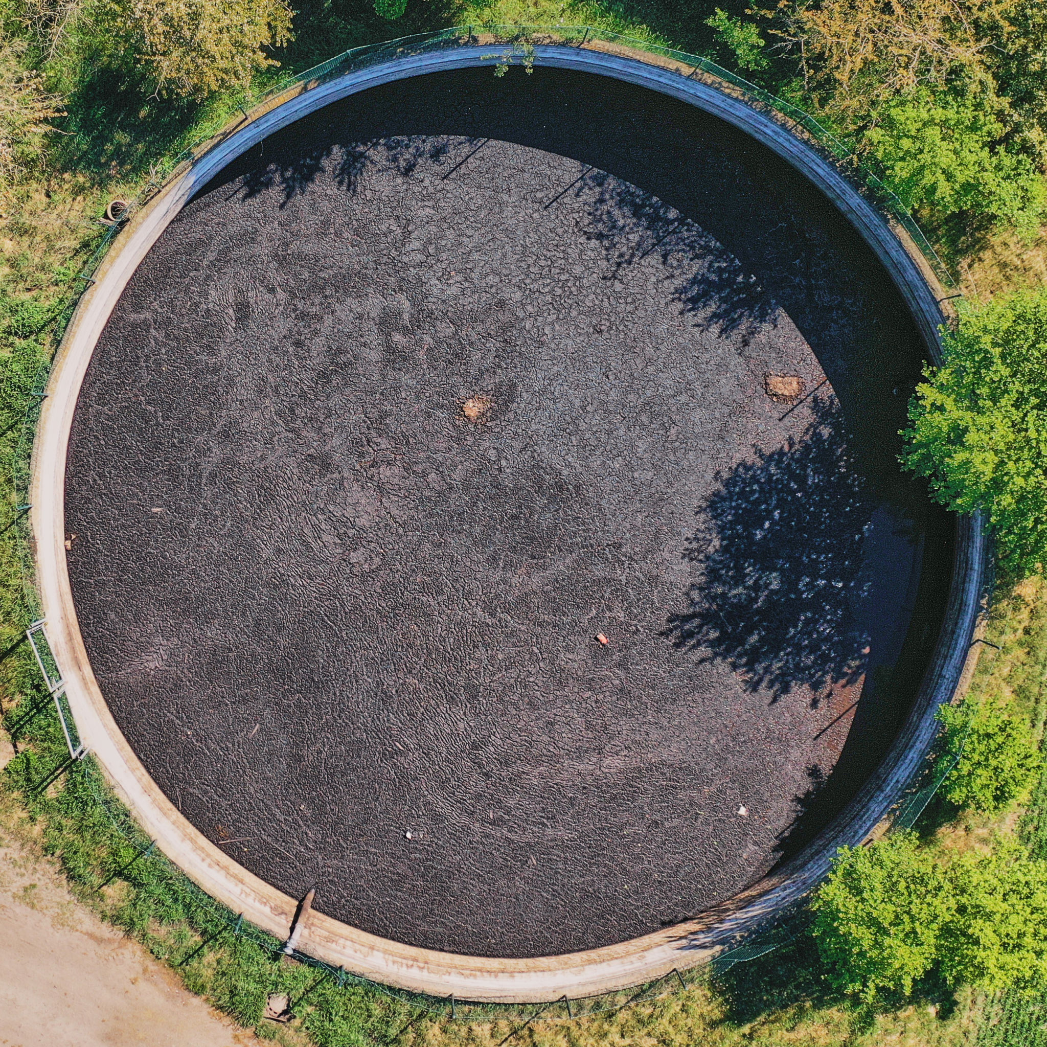 Vertical view down to a large circular tank for the storage of liquid manure Vertical view down to a large circular tank for the storage of liquid manure