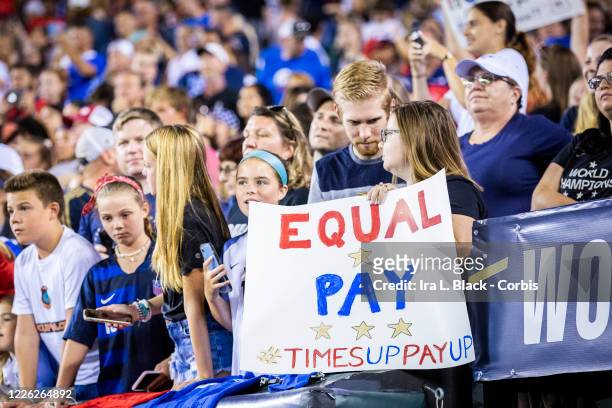 Fan holds up a sign that says "Equal Pay Times Up Pay Up" in support of the United States Women's National Team fight for equal pay. This was during...