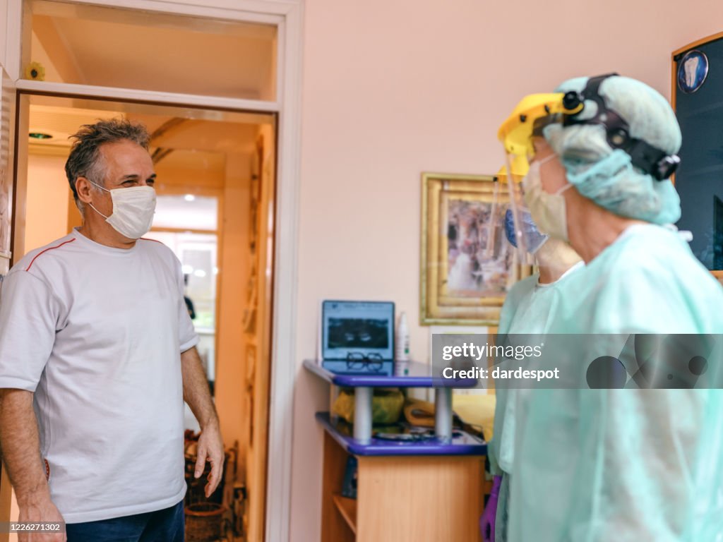 Dentist and His Assistant Make Appointment on Reception in Dental Clinic