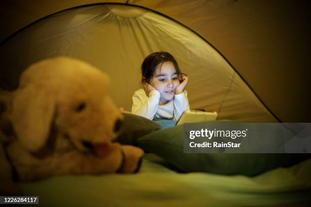 camping time! - girl rain night stock pictures, royalty-free photos & images