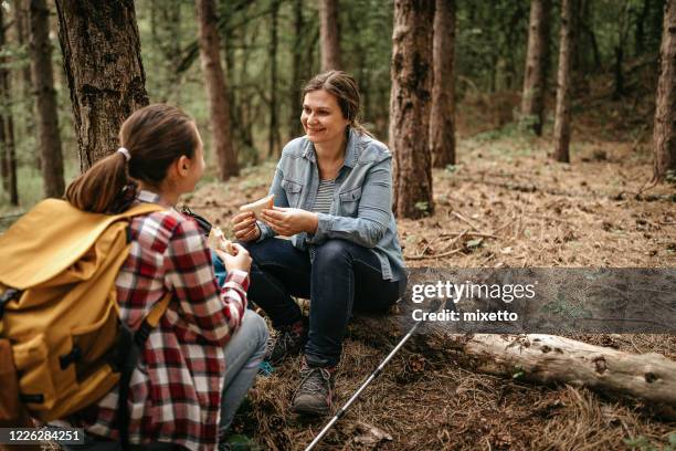 mother and daughter eating sandwich on hiking tour - teenagers eating with mum stock pictures, royalty-free photos & images