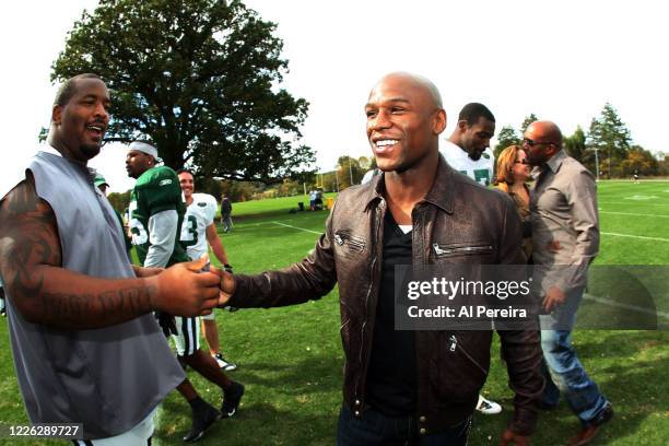 Boxer Floyd Mayweather, Jr. Meets with New York Jets player Kris Jenkins when he visits the New York Jets practice at the Atlantic Health Jets...