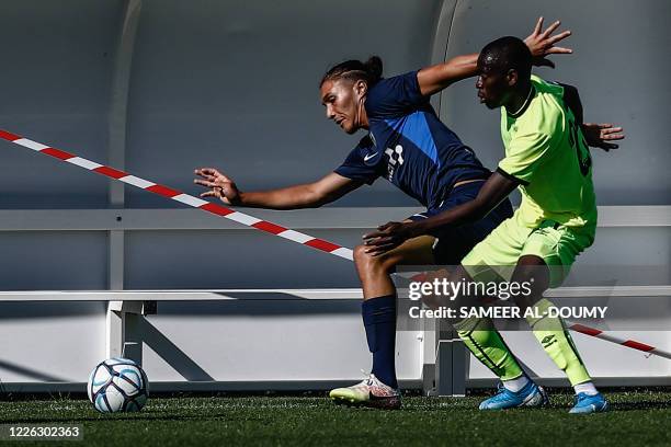 Paris FC's French defender Jaouen Hadjam vies with a Caen's player during the French L2 friendly football match between Caen and Paris FC at the...