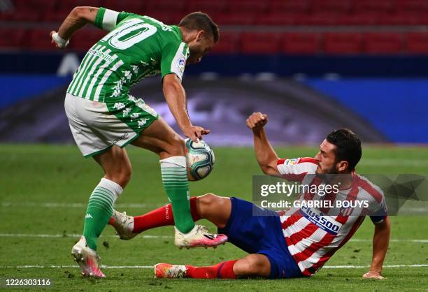 Real Betis' Spanish midfielder Sergio Canales vies with Atletico Madrid's Spanish midfielder Koke during the Spanish league football match between...