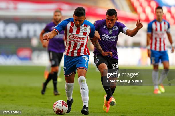Alexis Vega of Chivas fights for the ball with Paul Rocha of Mazatlan during the match between Chivas and Mazataln FC as part of the friendly...