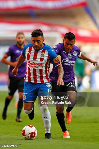 Alexis Vega of Chivas fights for the ball with Paul Rocha of Mazatlan during the match between Chivas and Mazataln FC as part of the friendly...
