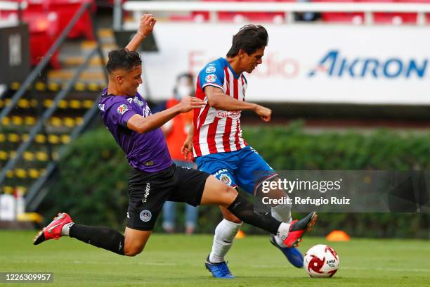 José Macías of Chivas fights for the ball with Nicolas Diaz of Mazatlan during the match between Chivas and Mazataln FC as part of the friendly...
