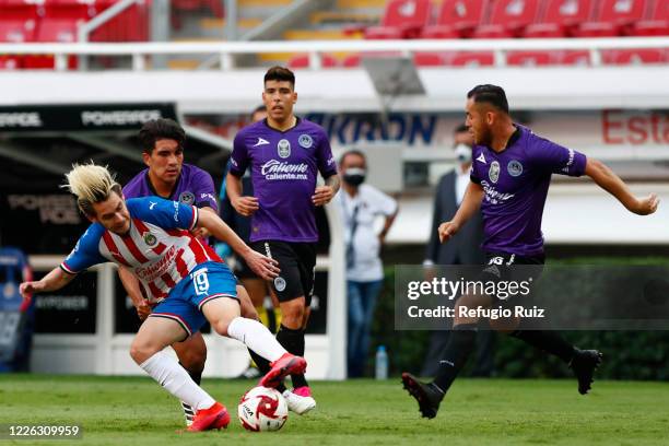 Jesús Angulo of Chivas fights for the ball with David Arce of Mazatlan during the match between Chivas and Mazataln FC as part of the friendly...