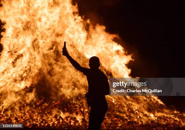 Young loyalist man is seen dancing at the Ballycraigy estate 11th night bonfire on July 11, 2020 in Antrim, Northern Ireland. Loyalists traditionally...