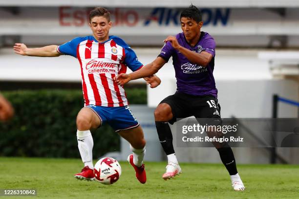 Isaac Brizuela of Chivas fights for the ball with Candido Ramirez of Mazatlan during the match between Chivas and Mazataln FC as part of the friendly...