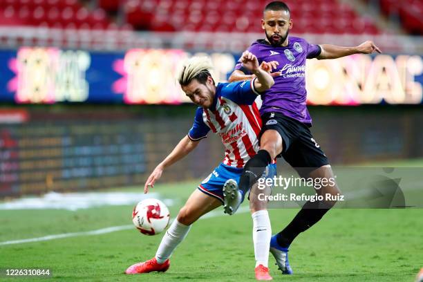 Jesús Angulo of Chivas fights for the ball with Antonio Padilla of Mazatlan during the match between Chivas and Mazataln FC as part of the friendly...