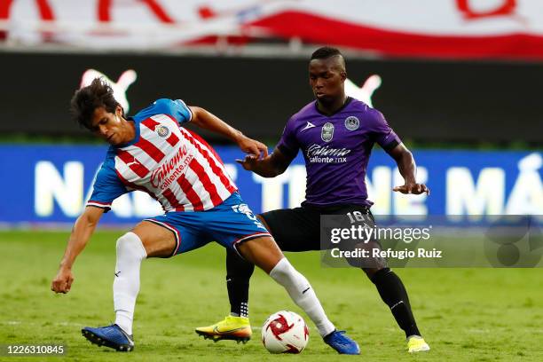 José Macías of Chivas fights for the ball with Enrique Ortiz of Mazatlan during the match between Chivas and Mazataln FC as part of the friendly...