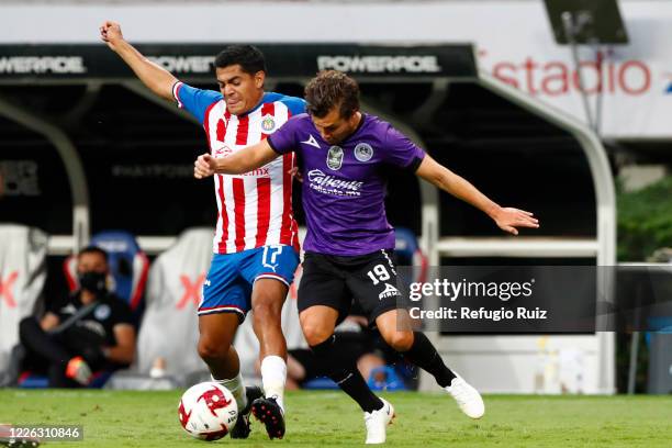 Jesus Sanchez of Chivas fights for the ball with Manuel Perez of Mazatlan during the match between Chivas and Mazataln FC as part of the friendly...