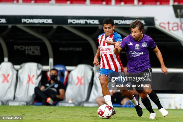 Jesus Sanchez of Chivas fights for the ball with Manuel Perez of Mazatlan during the match between Chivas and Mazataln FC as part of the friendly...