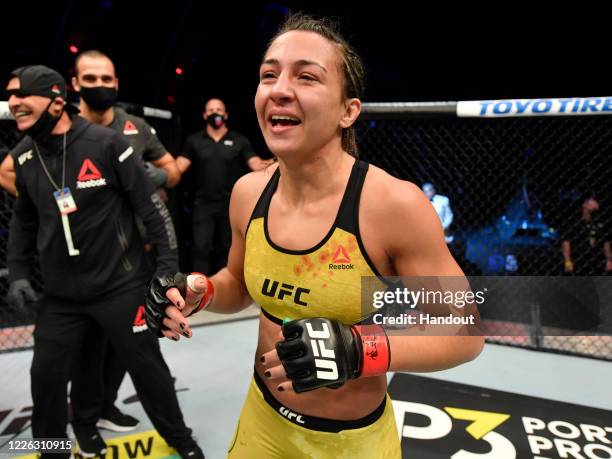 In this handout image provided by UFC, Amanda Ribas of Brazil celebrates after her victory over Paige VanZant in their flyweight fight during the UFC...