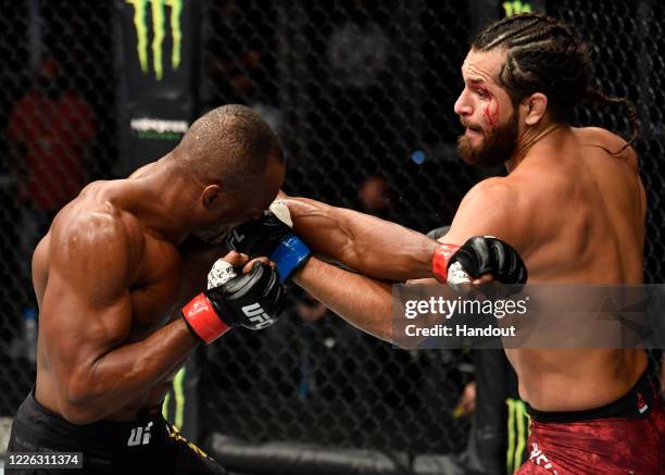 In this handout image provided by UFC, Jorge Masvidal punches Kamaru Usman of Nigeria in their UFC welterweight championship fight during the UFC 251...