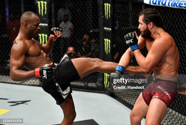 In this handout image provided by UFC, Kamaru Usman of Nigeria kicks Jorge Masvidal in their UFC welterweight championship fight during the UFC 251...