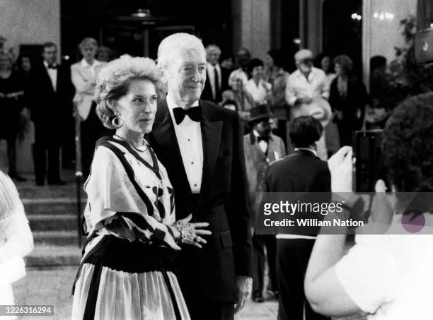 American actress and model Gloria Hatrick McLean and husband American actor and military officer Jimmy Stewart arrive at the Women's Wear Daily party...
