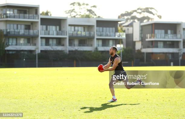 Tom Mitchell of the Hawks takes the ball during a Hawthorn Hawks AFL training session at Waverley Park on May 22, 2020 in Melbourne, Australia.