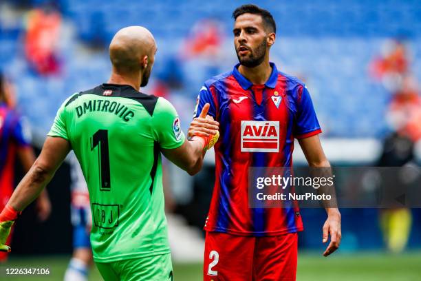 Dmitrovic of SD Eibar and 02 Esteban Burgos of SD Eibar during La Liga match between RCD Espanyol and SD Eibar at RCD Stadium on June 13, 2020 in...