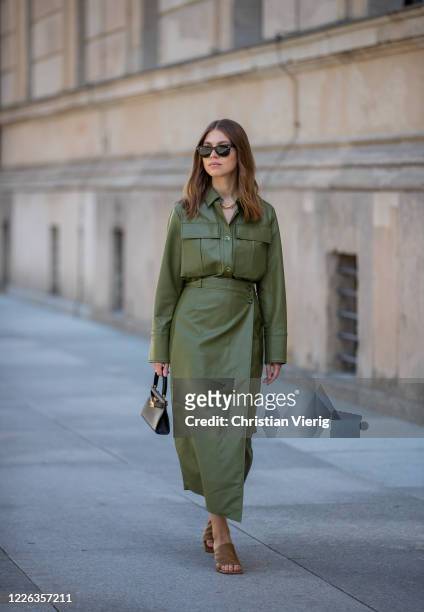 Swantje Soemmer is seen green leather skirt and button shirt Aeron, brown mules Zara, black Tory Burch bag, Ray Ban sunglasses on May 21, 2020 in...