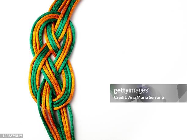 a string bracelet with sailor knots on a white background - celtic knot stock-fotos und bilder