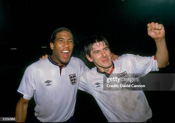 John Barnes and Peter Beardsley of England celebrate victory after the European Championship qualifying match against Yugoslavia played in Belgrade,...