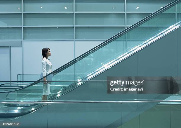 image of business woman - escalator side view stock pictures, royalty-free photos & images