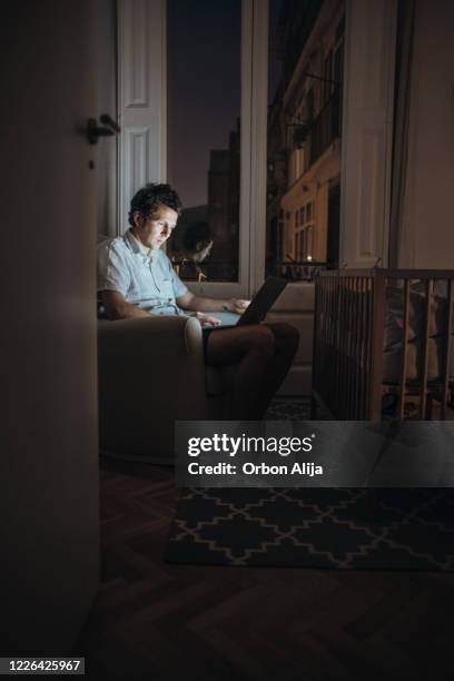 father working on children's bedroom while they fall asleep - nursery night stock pictures, royalty-free photos & images