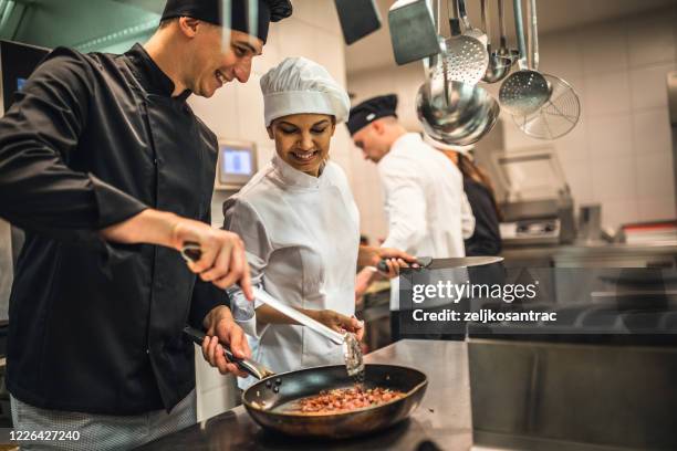 the team of cooks backs in the work in the modern kitchen, - hotel occupation stock pictures, royalty-free photos & images