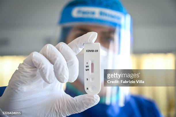Rapid serological test is carried out in the molecular biology laboratory of Cannizzaro Hospital on May 22, 2020 in Catania, Italy. Restaurants,...
