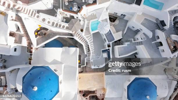 overhead aerial view of three blue domes church in oia town on santorini island, greece - mediterranean-blue-roof-santorini stock pictures, royalty-free photos & images