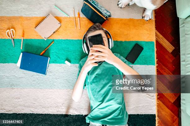 teenager boy with smartphone at home top view - boys bedroom stock-fotos und bilder