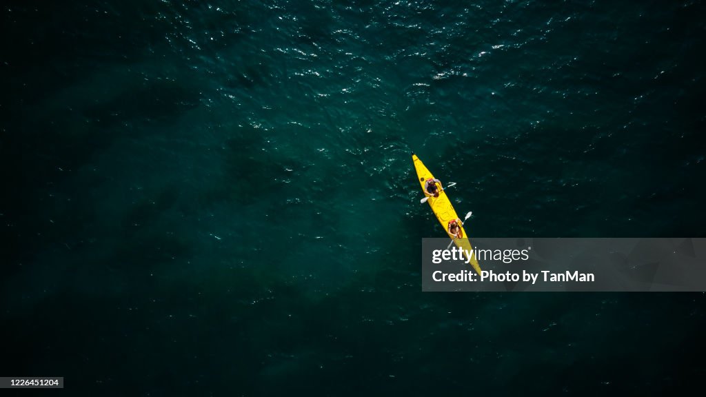 Tandem Yellow Kayak in dark green waters of Wanaka