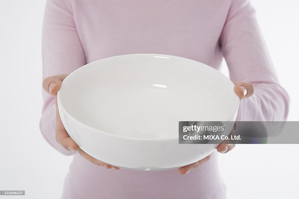 Woman holding empty bowl